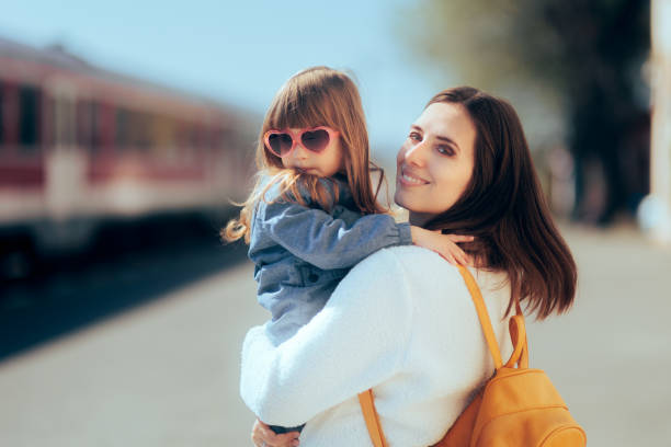 Mother and Daughter Waiting to get on the Train Together stock photo