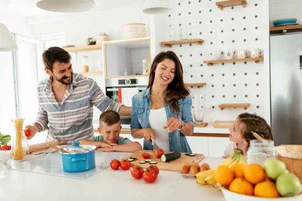Mother and father preparing breakfast with children. stock photo stock photo