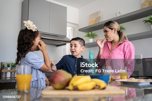 istock Mother and kids having breakfast at home 1398808737