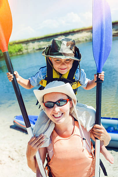 Mother and son kayaking stock photo