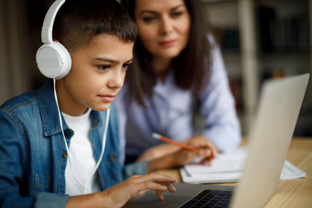 Mother and son using laptop at home  homework stock pictures, royalty-free photos & images