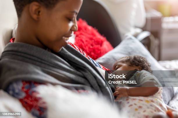 Mother Breastfeeding Baby At Home