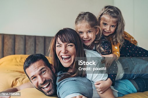 istock Mother, father and twin girls stacked on top of each other 1216288584