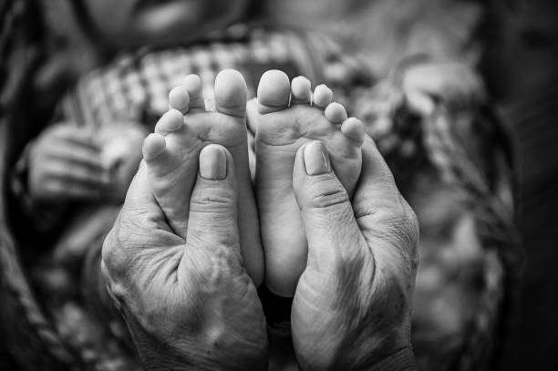 Mother hands, love, family, foots in hands stock photo