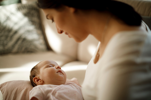 Mother Holding Her Sleeping Baby Girl Stock Photo - Download Image Now ...