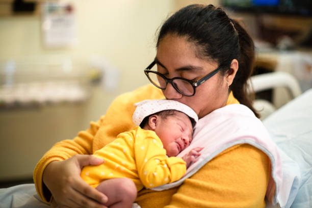 Mother Holding Newborn Baby at Hospital stock photo