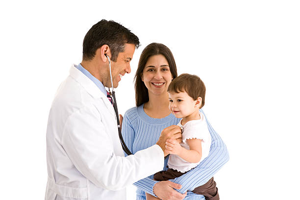 Mother holding toddler while doctor listens to heartbeat stock photo
