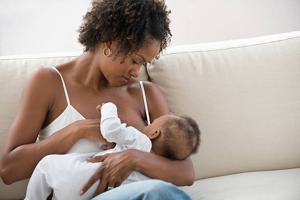 mother nursing son - breastfeeding stockfoto's en -beelden