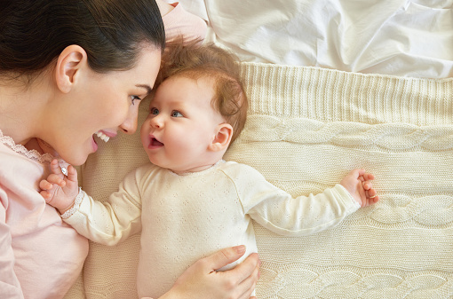 mother playing with her baby stock photo