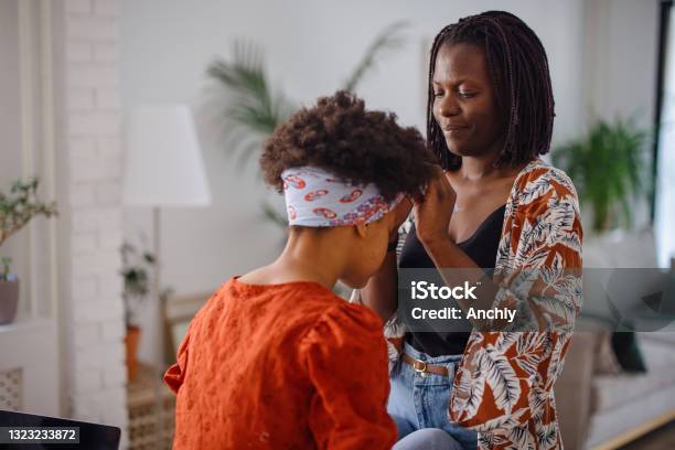 Mother styling daughter's hair
