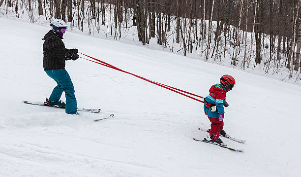 Mother Teaching Daughter to Ski at Mont-Tremblant Ski Resort stock photo