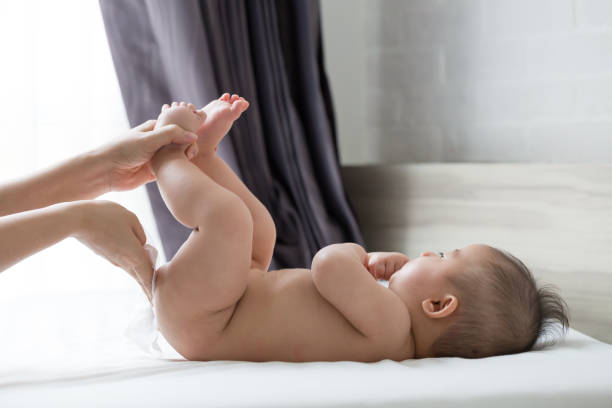 Mother wipe the bottom and the body baby with wet tissues after bath Mother wipe the bottom and the body baby with wet tissues after bath changing baby diaper stock pictures, royalty-free photos & images