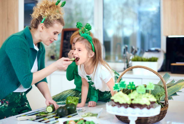 Mother with daughter cooking at kitchen Mother with daughter cooking at kitchen irish women stock pictures, royalty-free photos & images