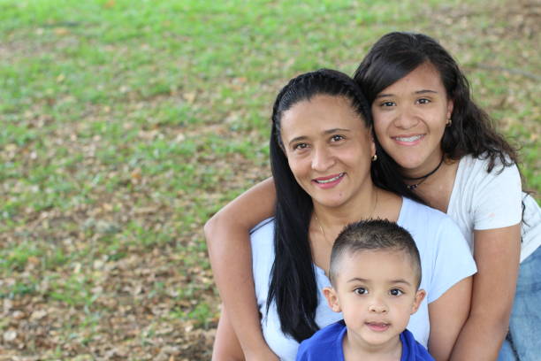 Mother with son and daughter in the park Mother with son and daughter in the park. colombian ethnicity stock pictures, royalty-free photos & images