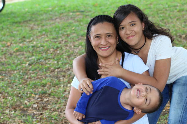 Mother with son and daughter in the park Mother with son and daughter in the park. mexican teenage girls stock pictures, royalty-free photos & images