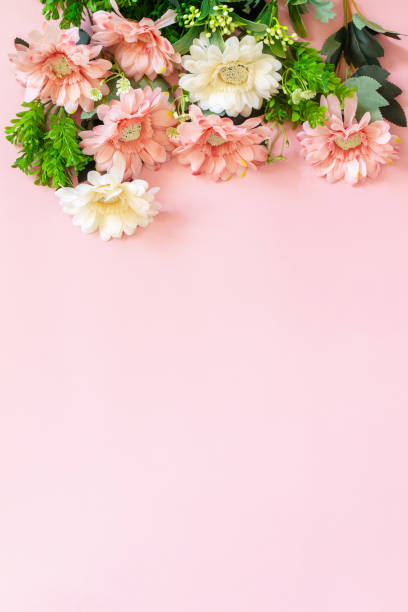 Mother's day or birthday greeting card concept. Festive flower arrangement on a pastel pink background. Top view flat lay. Copy space. stock photo