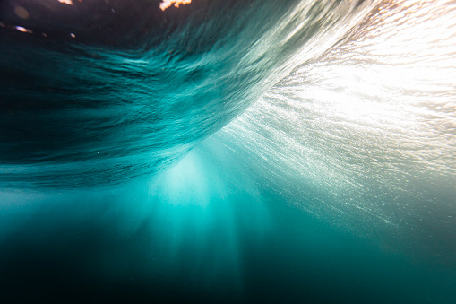 Motion blur of smooth deep blue ocean wave under the waters surface