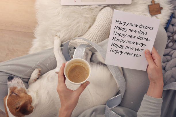 Motivational and Inspirational New Year quotes. Woman holding Handmade Greeting Card Motivational and Inspirational New Year quotes. Woman holding Handmade Greeting Card happy new year dog stock pictures, royalty-free photos & images