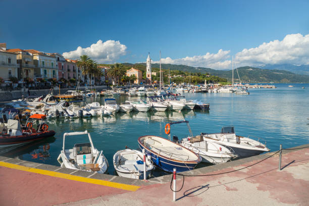 Motor boats and yachts in the harbor of Scario on a sunny summer day in the mediterranean sea, Cilento, Campania, Italy stock photo