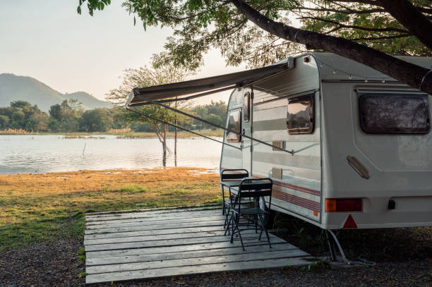 Motor home parked near lakeside in campground at evening stock photo