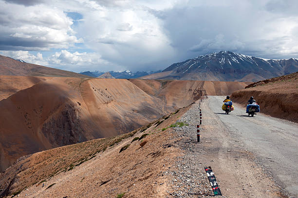 Motorbikers on Cloudy Day Plateau Mora India Two men on motorbikes traveling on beautiful tableland Mora, Leh-Manali highway, Ladakh, northern India. ladakh region stock pictures, royalty-free photos & images