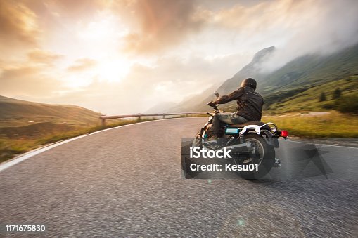 istock Motorcycle driver riding in Dolomite pass, Italy, Europe. 1171675830