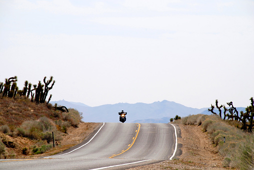 Inyokern, California, 04/08/2012motorcycle riding in high desert on highway through  Joshua trees