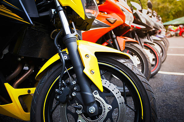 motorcycles standing in the row motorcycles standing in the row on asphalt road closeup tire vehicle part stock pictures, royalty-free photos & images