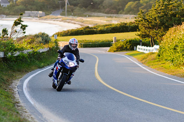 Motorcyclist leaning into curve stock photo