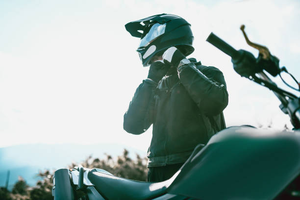 motocycliste de matériel spécialisé, s’apprête à ride - casque moto photos et images de collection