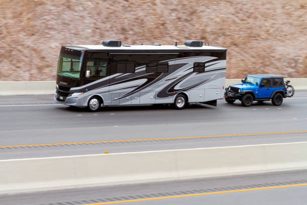 RV motorhome bus towing a jeep on Interstate 11 stock photo