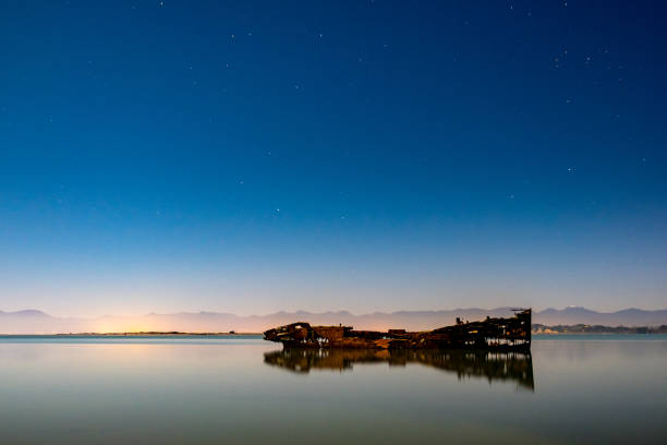 Motueka Ship Wrecked at night. The famous ship in tasman coast area. Motueka Ship Wrecked at night. The famous ship in tasman coast area. capsizing stock pictures, royalty-free photos & images