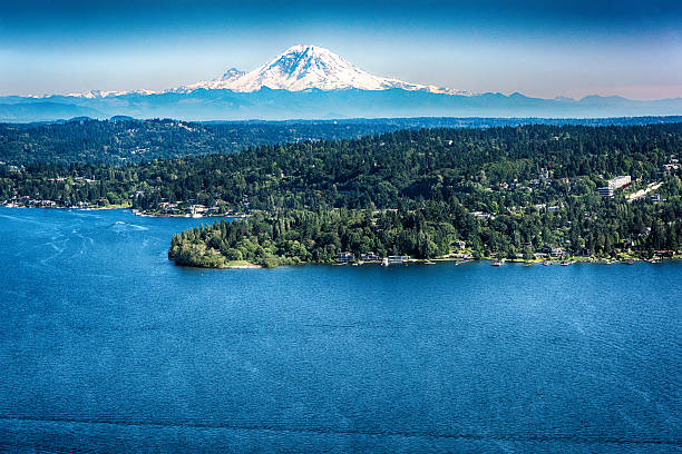 Mount Ranier View From Above Lake Washington The glacier of Mount Ranier in the Cascade Mountain Range shot from over Lake Washington just east of Seattle. mt rainier stock pictures, royalty-free photos & images