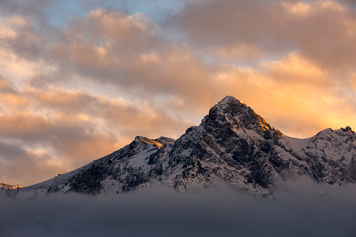 A peak in the Sneffels Range, S9 peeks out of the clouds in time to shine in the setting sun.