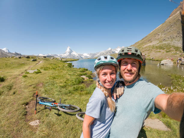 Mountain bikers on trail take selfie stock photo
