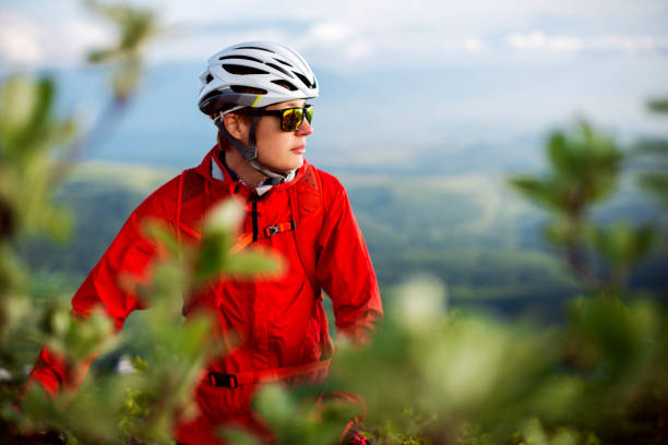 Mountain biking A female biker is having a ride in the mountains. georgijevic mountain biker stock pictures, royalty-free photos & images