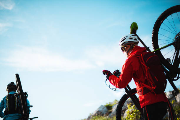 Mountain biking Male and female bikers are having a ride in the mountains. georgijevic mountain biker stock pictures, royalty-free photos & images