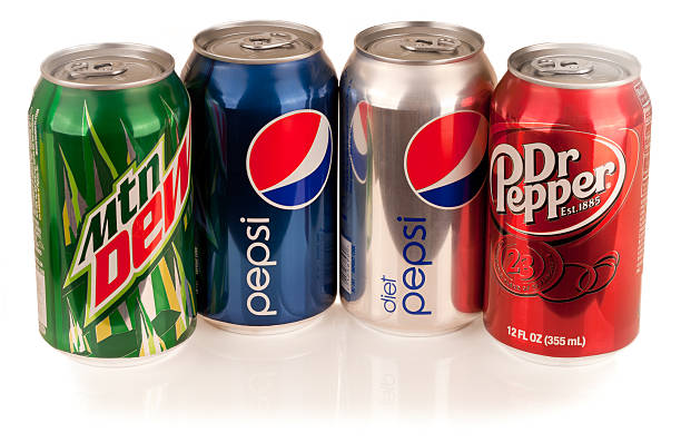 Mountain Dew, Diet and Regular Pepsi, Dr. Pepper Cans "Portland, Oregon, USA - June 22, 2011 - Four twelve-ounce aluminum cans of Coca Cola\'s American rival sodas, including Dr. Pepper and three PepsiCo beverages: Pepsi Cola, Diet Pepsi, and Mountain Dew." doctor pepper soda stock pictures, royalty-free photos & images