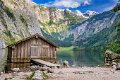 istock Mountain lake fishing hut surrounded high mountain-range 174787016