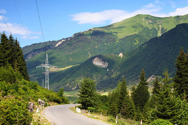 Mountain landscape with asphalt road and power line stock photo