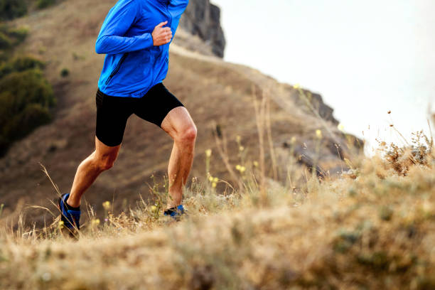 mountain marathon running uphill athlete men runner stock photo