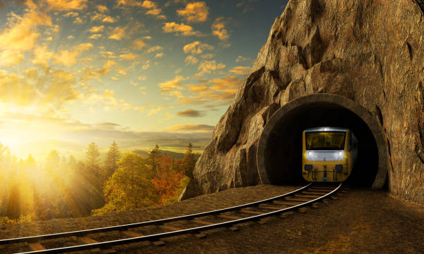 Mountain railroad with train in tunnel in rock above landscape. stock photo