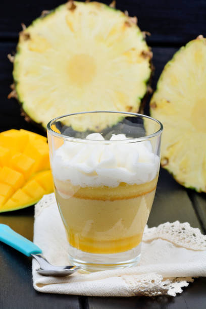 Mousse of mango fruit and pineapple in a glass jar stock photo