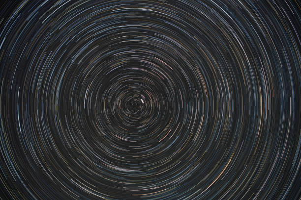 Movement of stars around pole star on north hemisphere. Startrails on night sky, long exposure composition. stock photo