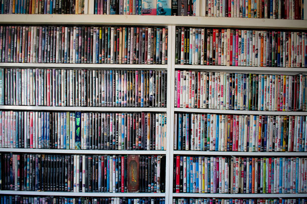 Movie collection on a shelf Movies in DVD cases on a shelf used as decoration for a pub dvd stock pictures, royalty-free photos & images