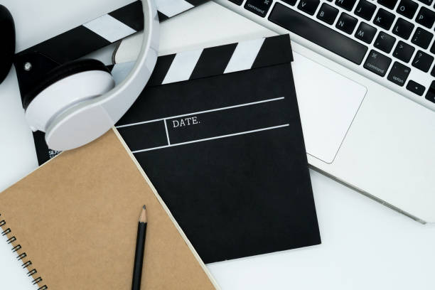 Movie maker with movie editing device,laptop, earphone, movie clapper board, note pad on white background. Movie maker with movie editing device,laptop, earphone, movie clapper board, note pad on white background. film script stock pictures, royalty-free photos & images