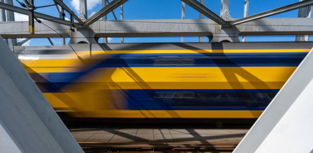 Moving train on a steel bridge stock photo
