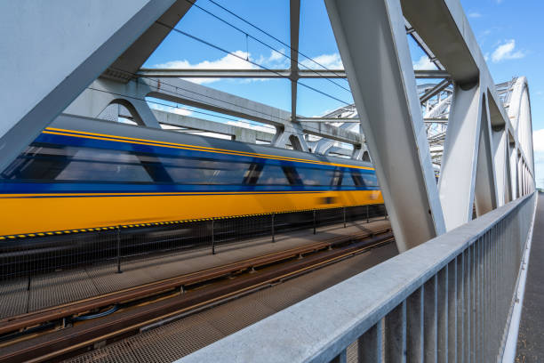 Moving train on a steel bridge stock photo