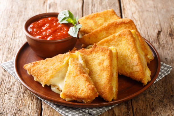 Mozzarella in Carrozza Golden Grilled Cheese Sandwiches closeup in the plate. horizontal stock photo