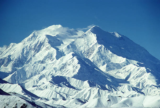 Mt. McKinley, Alaska, mountaintop Mt. McKinley in full sunlight, capped by just a few clouds. hearkencreative stock pictures, royalty-free photos & images